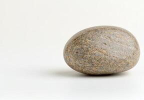 Smooth pebble on a plain background photo