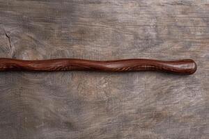 Rustic wooden texture background with a curved wooden stick photo