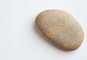 Smooth stone on white background photo
