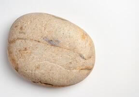 Smooth river rock on white background photo