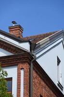 a building with a roof and a gutter photo