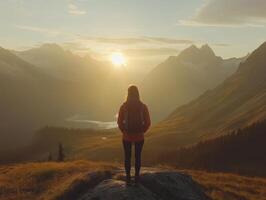woman mountain climbers from behind watching sunset photo