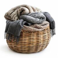A beautiful still life of a wicker basket filled with soft, colorful blankets. The muted colors and natural textures create a warm and inviting feeling. photo