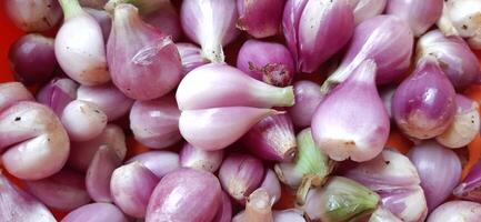Pile of fresh red onions Sumenep or bawang merah Sumenep background Indonesia photo
