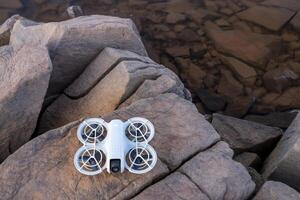 Fort Collins, CO, USA - October 1, 2024, DJI Neo mini drone on sandstone rocks, It offers a creative and fun alternative to a selfie stick or tripod. photo