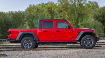 Fort Collins, CO, USA - October 2, 2024 - A new Jeep Gladiator pick up, Rubicon model at a trailhead parking. photo