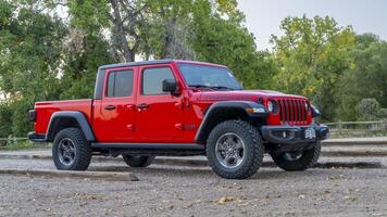 Fort Collins, CO, USA - October 2, 2024 - A new Jeep Gladiator pick up, Rubicon model at a trailhead parking. photo