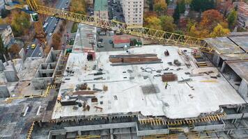 Aerial view of a new construction site. Top view on a roof of high-rise building in autumn on the city background. video