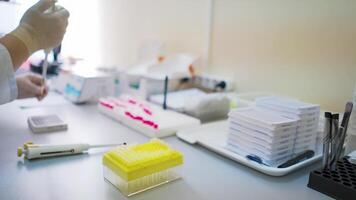 Medical laboratory. Female researcher working with test tubes on the table. Hands of a lab specialist doing analysis with samples indoors. video