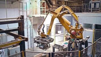 Industrial robot arm at a modern factory. Manufacturing production. Advanced robotic machine loading packed bags. Innovative technologies indoors. video