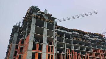 Construction of high-rise building. Front view of huge building in the process of construction. New construction site in the city. video