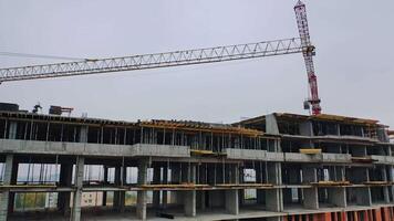 Construction site in a megacity. shooting with drone. New house in a residential complex. Motion camera back. video