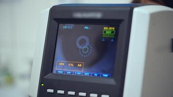 Auto refractometer testing human eye. Data screen showing progress of an eye examination. Vision concept. video