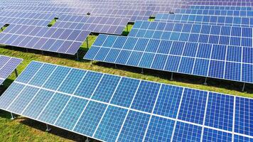Aerial view of a huge electricity farm. Solar panels on the field in the rows at sunlight. Photovoltaic panel system. Alternative source of energy. video