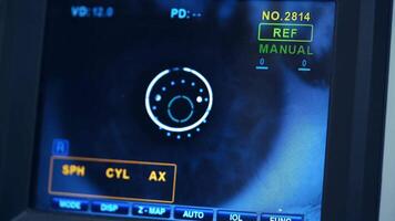 Refractometer machine. Patient testing eyes in clinic. Screen showing progress of eye examination. Close-up. video