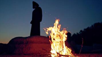 Old evil witch conjures in the wizarding lair. Scary Halloween concept. Burning fire. video