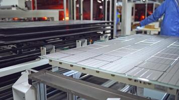 Producing process of solar panel. Automated technology of producing solar cells. Ready solar panel on the board on a modern factory background. video