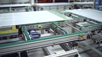 Close-up work of automated equipment for producing solar panels. Modernized factory with innovative technologies indoors. video
