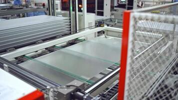 Robotic machine makes solar panel indoors. Automated technology of producing solar cells in a modern factory. video