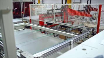 Solar panel is moving on a conveyor belt. Automated machine for producing solar cells inside the modern factory. video