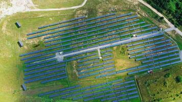 Rows of solar panels on the field. View from above on a modern renewable energy farm in the rural place. Aerial view. Camera moves around. video