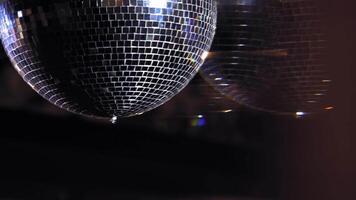 Disco ball is spinning. Round mirror ball reflecting real club lights and lasers. Evening party. Reflection of light. Lighting device. video