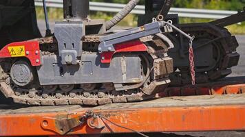 Caterpillar excavator in motion. Close-up of a caterpillar crawler machine that moves on metal support. Slow motion. video