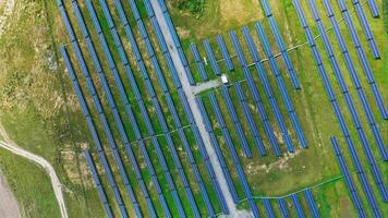 Aerial view on eco electricity farm in summer. Huge solar system of rows of energy panels on the field. Camera moves top down. video