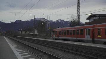 April 15, 2024, Prien am Chiemsee, Germany. Railway station DB in foothills in Bavaria Prien am Chiemsee in evening. Bahnhof Prien a Chiemsee. Deutschen Bahn und der Bayerischen Regiobahn Zug. video