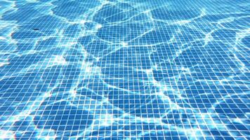 Bottom of the swimming pool. Clear water background with the reflection of sun rays underwater. Someone swims in the pool. Amazing view from underwater camera. video