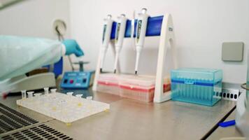 Analysis in small plastic tubes on a rack. Laboratory background and technician making experiments with test tubes on the table. Close-up. video
