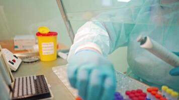 Worker in the laboratory. Laboratory technician in protective uniform is making research with different samples in clinic. Close-up. video