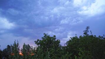 Lightning on the cloudy sky in summer. Strong and impressive lightning on the sky with bright clouds over the top of green trees. video