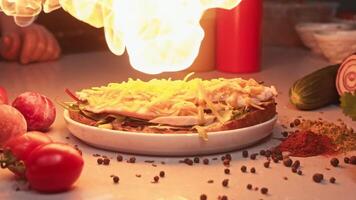 Grated cheddar cheese, which is used to make sandwiches, is melted and then fried over an open flame before being served to customer. Slow motion video