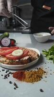 Thinly sliced cucumber slices without the skin are added to a sandwich made with a toasted baguette. Vertical video