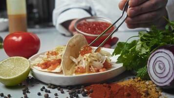 An exquisite high-end cuisine dish is served, featuring red caviar, a tortilla, and thinly sliced salmon. Close up video