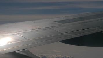 Airplane wing, view from the passenger seat in the porthole video
