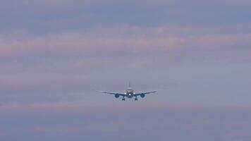 Passenger jet plane approaching landing. Commercial airplane in the sky, front view video