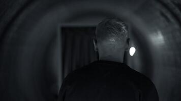 Rear view of a young rapper performer feeling anxiety before going on stage. Media. Man in a corridor with the effect of spinning walls. video