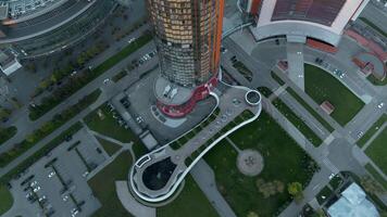 Modern glowing high-rise in daytime. Stock footage. Top view of modern high-rise building with luminous facade. Beautiful architecture of modern illuminated signboard during day video