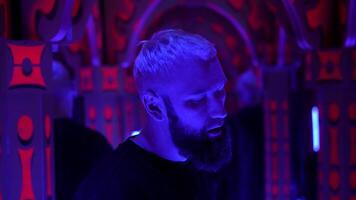 Cool hipster enjoying nightclub music and dancing. Media. Night club dancer hang out at techno party in neon light. video