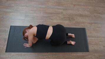 A woman from a knee elbow position making the bends of the body. Media. Concept of sport and body care. video