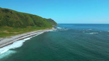 Breathtaking aerial view of the summer beach coastline. Clip. Wild empty sea shore and green fields. video