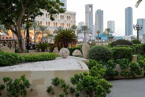 Sharjah, UAE, February 14, 2023 Al-Qasba mall and boats for rent on the Al-Qasba water channel photo