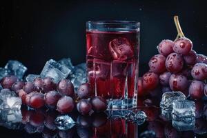 A Glass of Red Grape Juice with Ice Cubes and Fresh Grapes photo