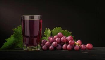 Glass of Grape Juice with Fresh Grapes and Green Leaves photo