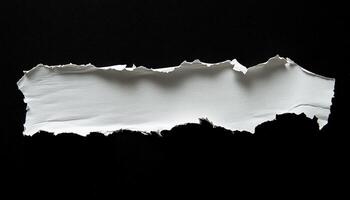 Torn White Paper with a Rough Edge Isolated on a Black Background photo