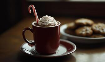 A red coffee cup with whipped cream on top and a red plate with a cookie on it photo