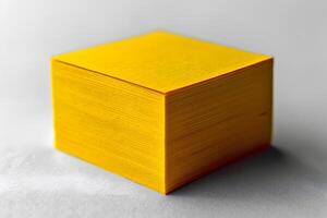 Stack of Bright Yellow Paper Sheets for Office Supply and Stationery Design photo