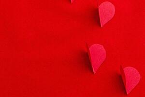 celebration composition with hand-cut paper hearts on a red background photo